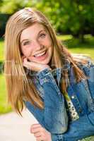 Portrait of smiling teenage girl outside