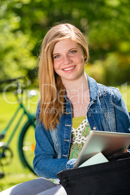 Student girl studying with tablet outside