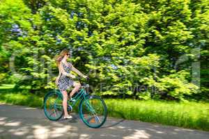 Young woman cycling during sunny summertime