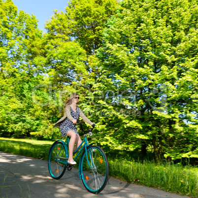 Happy woman riding fast her bike