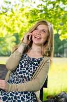 Laughing teenage girl talking on the phone