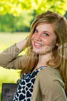 Portrait of smiling teenage girl posing outdoors