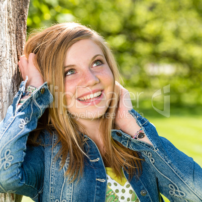 Lively smiling girl enjoying nature and sunshine