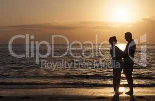 Happy Senior Couple Embracing on Sunset Beach