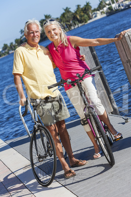 Happy Senior Couple on Bicycles By a River