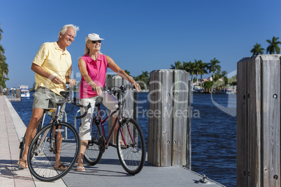 Happy Senior Couple on Bicycles By a River