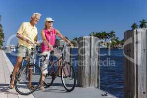 Happy Senior Couple on Bicycles By a River
