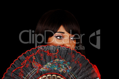 Girl behind fan.