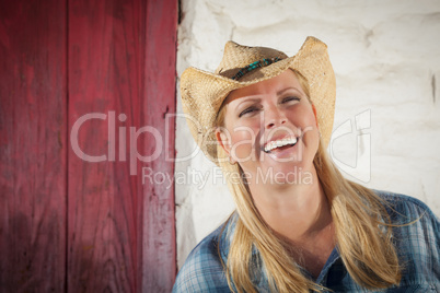 Beautiful Cowgirl Against Old Wall and Red Door