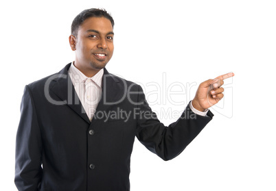 Indian business man pointing at blank space.