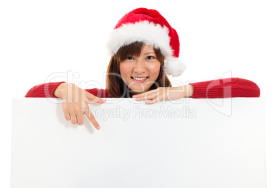 Christmas girl showing blank billboard banner