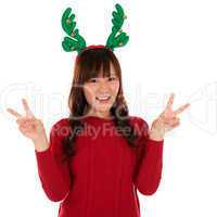 Asian Christmas girl showing victory sign.