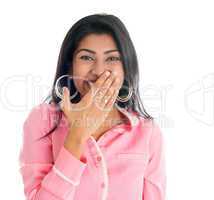 Indian woman giggles covering her mouth with hand