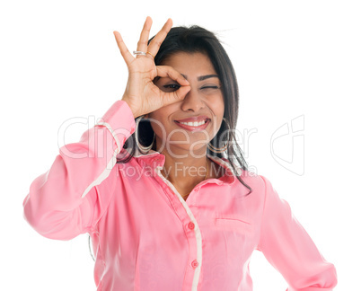 Indian business woman focused by hand hole.