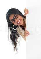 Indian businesswoman peeking from behind blank sign billboard
