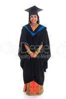 Full body happy Indian university student in graduation gown