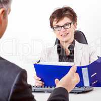 Business woman with folder speaks to man in a suit