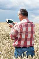 Farmer with computing machine in the field