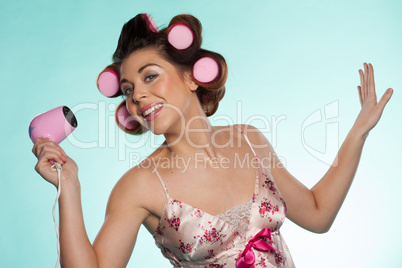 woman in haircurlers with hairdryer