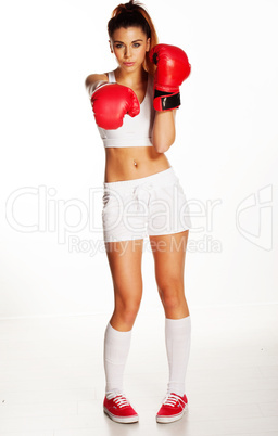 pretty young woman punching with red boxing gloves