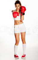 pretty young woman punching with red boxing gloves