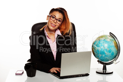 businesswoman with a world globe on her desk