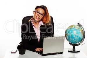 businesswoman with a world globe on her desk