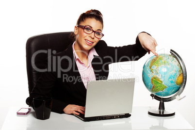 smiling manageress pointing to a globe