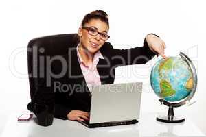 smiling manageress pointing to a globe