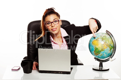 businesswoman pointing to a world globe