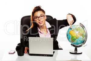 businesswoman pointing to a world globe