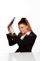 angry businesswoman about to smash her laptop