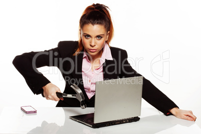 businesswoman fixing her laptop with a hammer