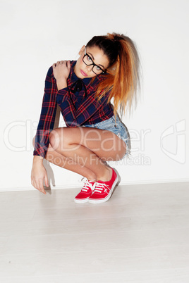 portrait of a pretty teenage girl crouching