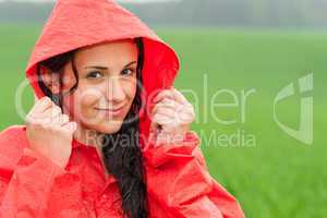 Adolescent girl in the rain in cloak