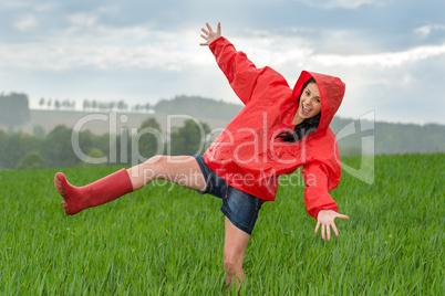 Playful teenage girl dancing in the rain