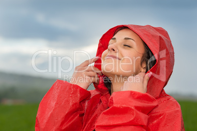 Young woman enjoying raindrops on her face