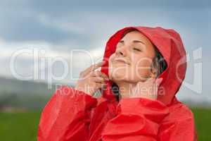 Young woman enjoying raindrops on her face