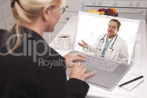 Woman In Kitchen Using Laptop - Online with Nurse or Doctor