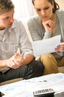 Troubled couple calculating finances