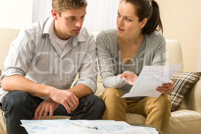 Worried couple talking about their expenses
