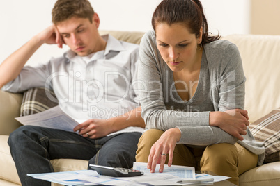 Annoyed couple calculating their finances