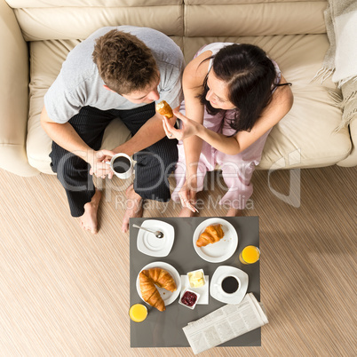 Carefree couple eating breakfast together