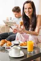 Smiling couple eating romantic breakfast