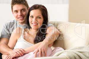 Carefree young couple embracing on couch