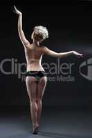 Graceful dancer posing topless back