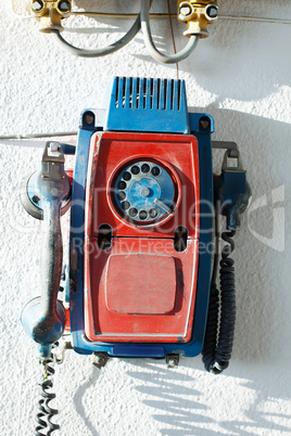 Old rotary phone on wall