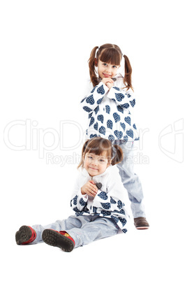 Identically dressed cute kids posing in studio