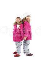 Identically dressed little girls posing in studio