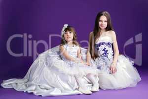 Pretty little girls posing on purple background